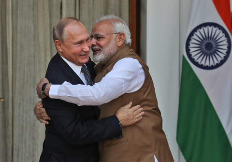 FILE - Indian Prime Minister Narendra Modi, right, hugs Russian President Vladimir Putin before their meeting in New Delhi, India, on Oct. 5, 2018. 