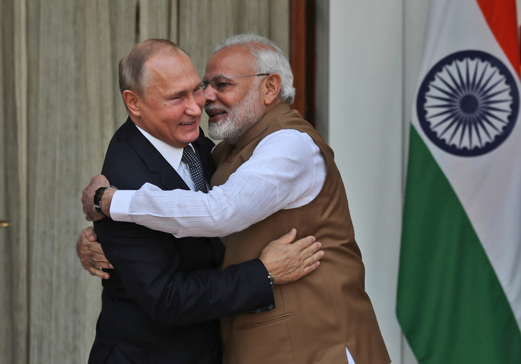 FILE - Indian Prime Minister Narendra Modi, right, hugs Russian President Vladimir Putin before their meeting in New Delhi, India, on Oct. 5, 2018. 