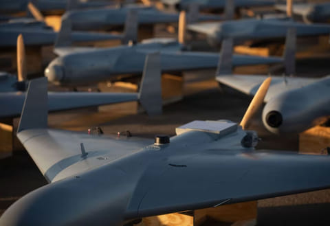 Unmanned Combat Attack System (LUCAS) drones are positioned on the tarmac at an undisclosed base in the US Central Command operating area, on November 23, 2025. The LUCAS platforms are part of a one-way attack drone squadron that CENTCOM recently deployed to the Middle East. 