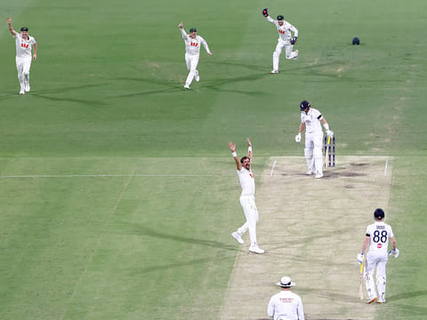 Australia’s Mitchell Starc (C) appeals successfully with team mates to dismiss England’s Joe Root (2nd R) on day three of the second Ashes Test at The Gabba in Brisbane on December 6, 2025. 