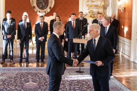 Czech President Petr Pavel (R) shakes hands with Andrej Babis (L), leader of the ANO ('YES') party, as he is appointed as the country’s new prime minister on December 9, 2025 at the Castle in Prague, Czech Republic.