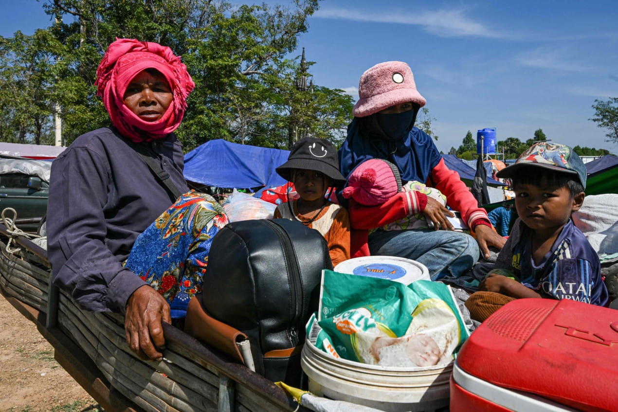 Residents gather outside a temple after they evacuated following clashes along the Cambodia-Thailand border, in Siem Reap province on December 9, 2025. Two more Thai soldiers were killed on December 9, in renewed border clashes with neighbour Cambodia, the Thai army said, raising the death toll for Thai troops to three.