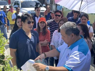 Actor-turned-Senator Ramon "Bong" Revilla JR (left, in navy blue shirt) visits an infrastructure project with Henry Alcantara (right) in Bulacan province, north of Manila. File photo.