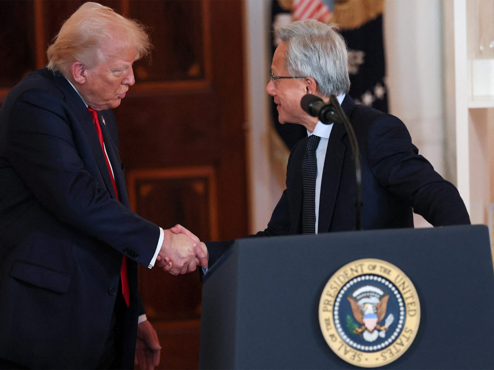 Nvidia CEO Jensen Huang and US President Donald Trump shake hands.
