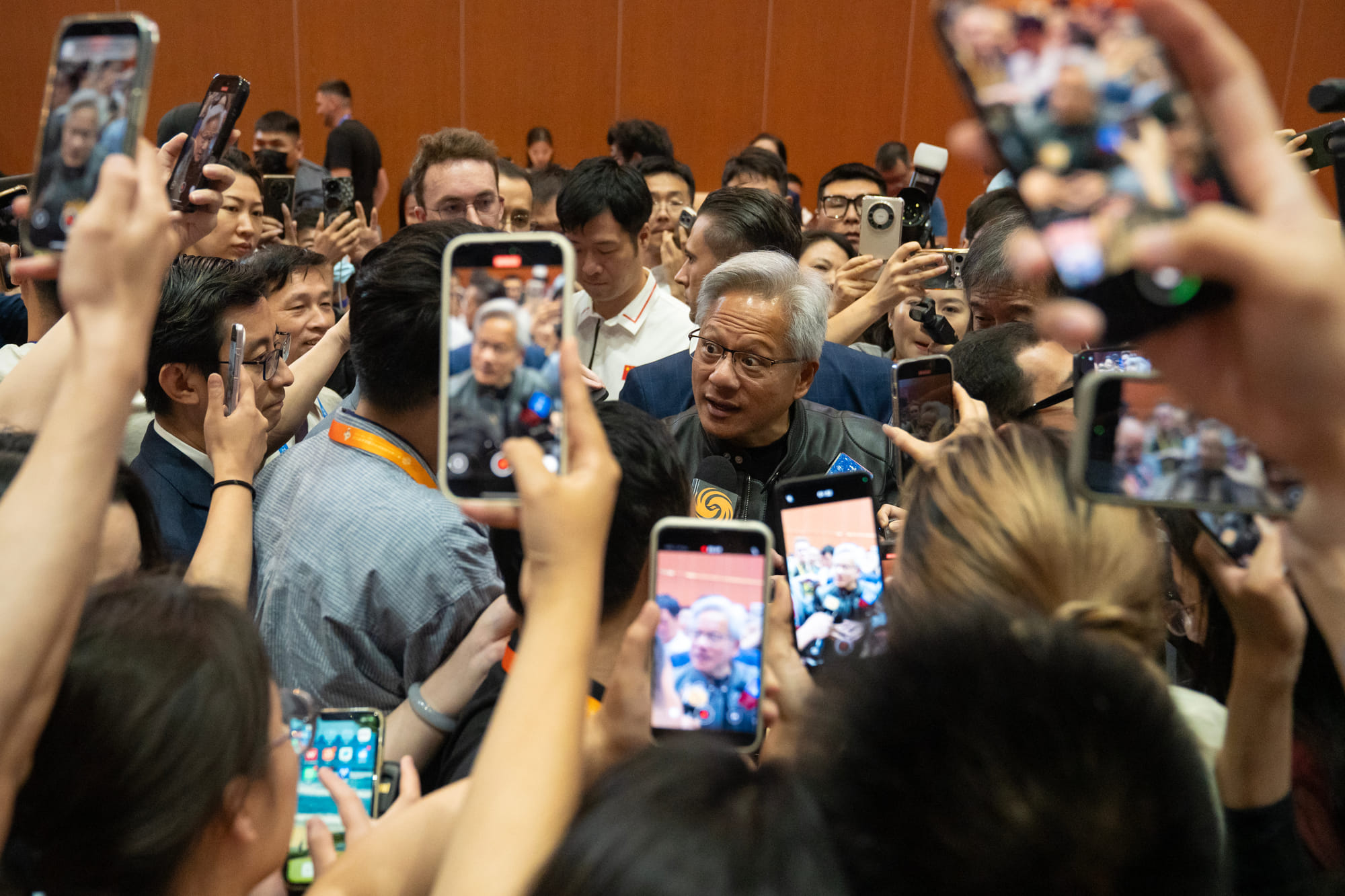 Jensen Huang, chief executive officer of Nvidia Corp., center, during the China International Supply Chain Expo in Beijing, China, on Thursday, July 17, 2025. 