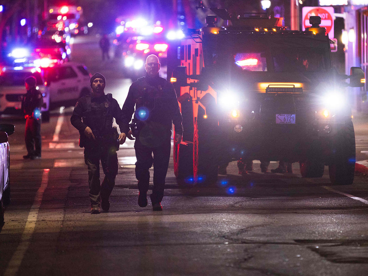 Police officers remain on the scene of a shooting that killed two and wounded at least eight at Brown University on December 13, 2025 in Providence, Rhode Island.