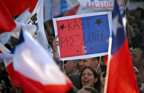 Supporters of Chile's presidential candidate Jose Antonio Kast, of the Partido Republicano party, celebrate following the first results of the presidential runoff election in Santiago on December 14, 2025.