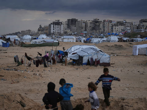 Palestinian children play next to tents in a makeshift camp for displaced people set up on the beach in Gaza City. Despite an October 10 ceasefire, Gaza remains gripped by daily violence as both the Israeli military and Hamas accuse one another of breaching the truce.
