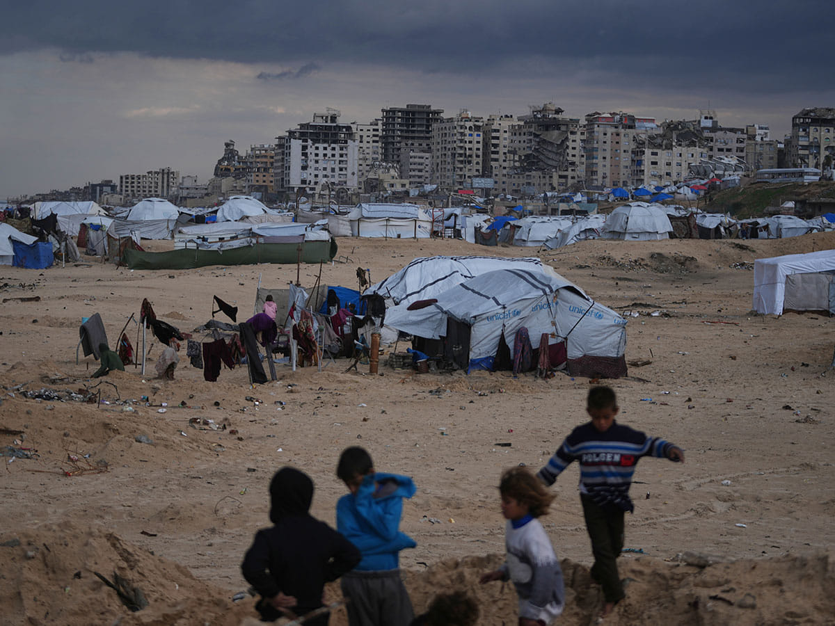 Palestinian children play next to tents in a makeshift camp for displaced people set up on the beach in Gaza City. Despite an October 10 ceasefire, Gaza remains gripped by daily violence as both the Israeli military and Hamas accuse one another of breaching the truce.