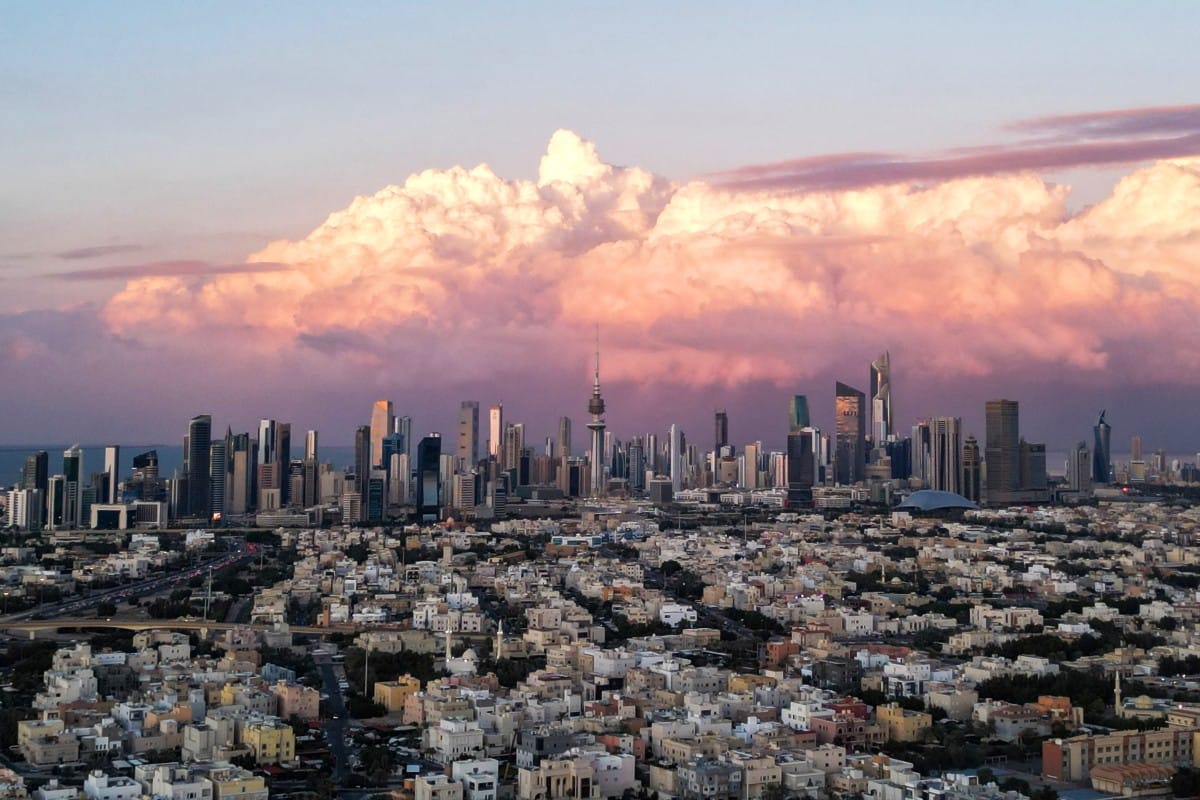 This aerial picture shows a view of Kuwait City and its skyline as the sun sets on December 17, 2025.
