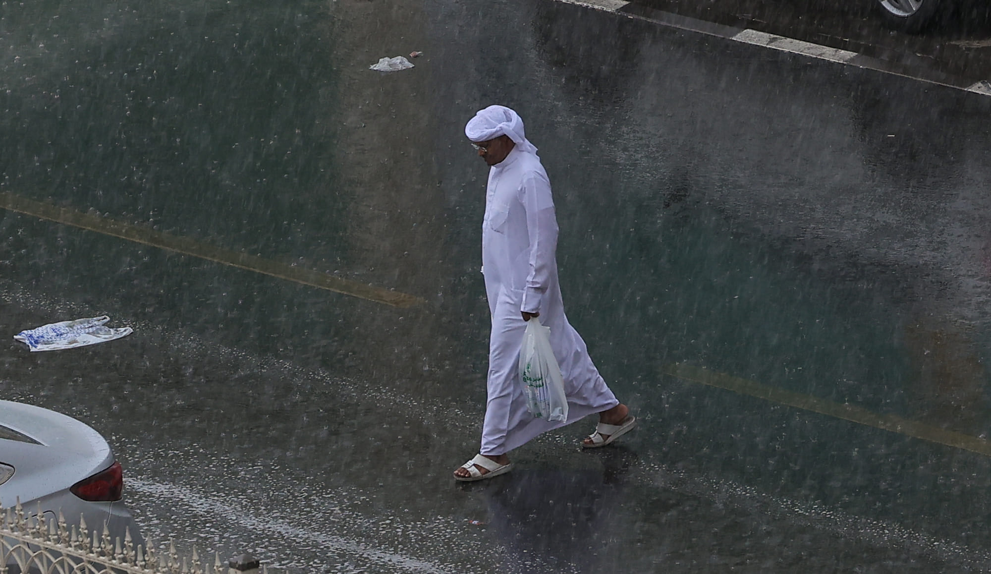 Residents caught in the rain at Al Majaz in Sharjah on Thursday.