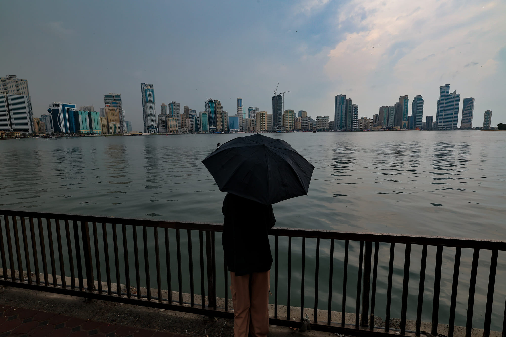 Residents caught in the rain at Al Majaz in Sharjah on Thursday.