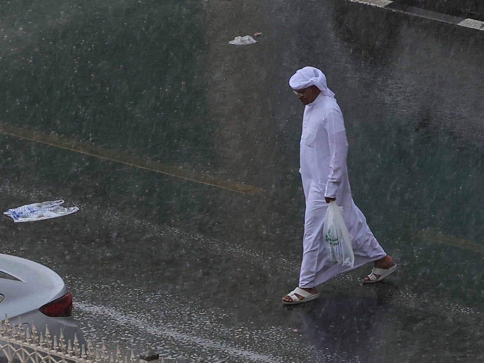 Residents caught in the rain at Al Majaz in Sharjah on Thursday.