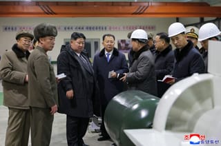 North Korean leader Kim Jong Un visits the manufacturing site of an 8,700-tonnage nuclear-powered strategic guided missile submarine at an undisclosed location in North Korea.