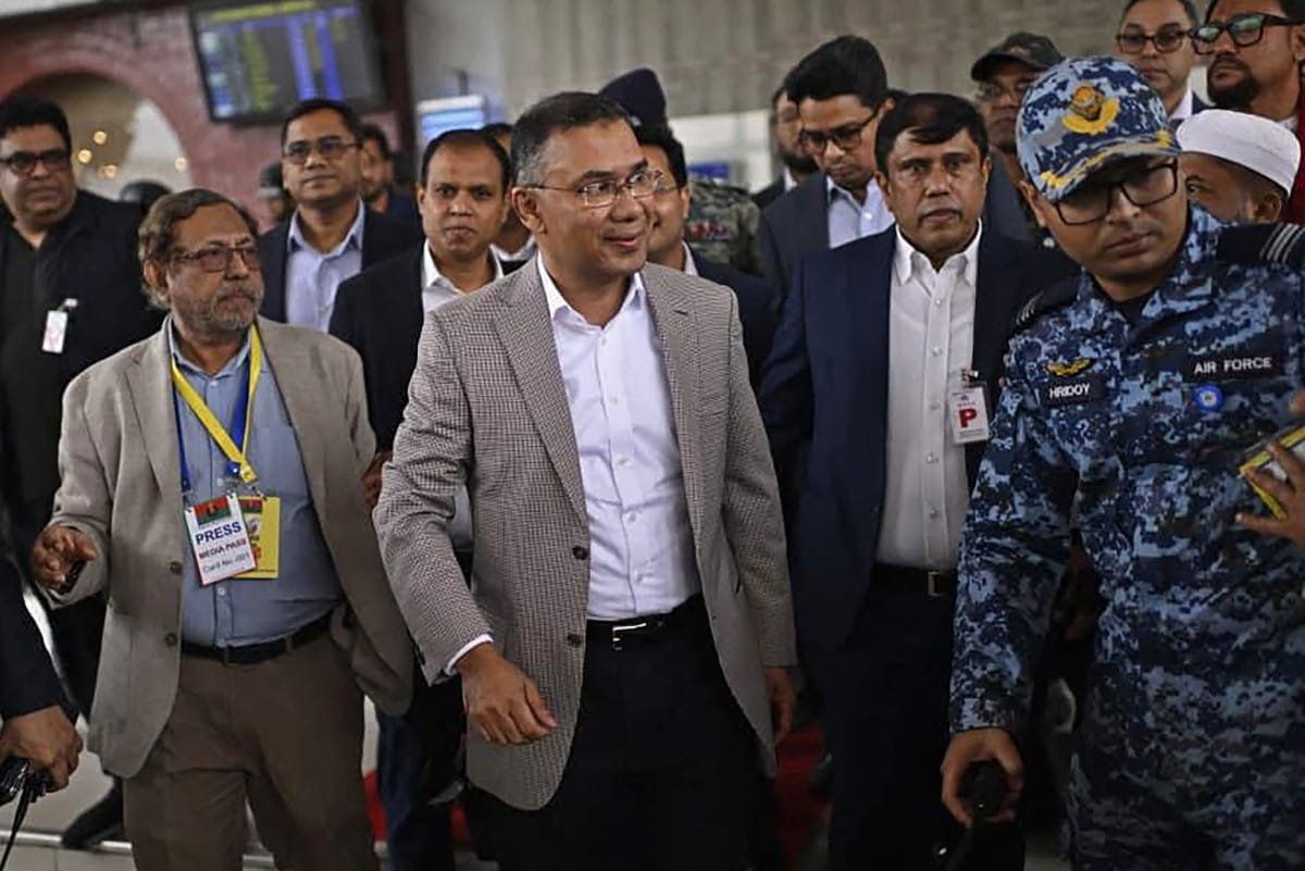 This handout photograph from the official Facebook page of the Bangladesh Nationalist Party (BNP) Media Cell taken and released on December 25, 2025 shows acting chairman of the Bangladesh Nationalist Party (BNP), Tarique Rahman (C) walking upon his arrival in Dhaka.