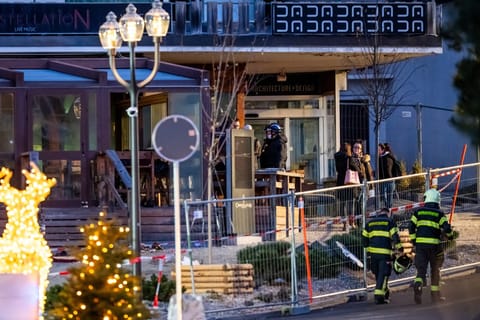 Rescuers are seen at the site of an explosion that ripped through a bar in Crans-Montana on January 1, 2026.