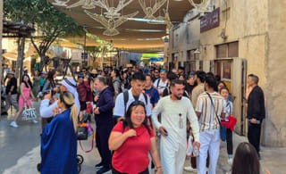 Tourists at Al Seef in Dubai on January 2, 2026, explore the heritage waterfront. The city was on course to welcome more than 17 million visitors in 2025, reinforcing its status as one of the world’s leading travel destinations.