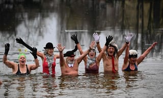 Swimmers across Europe brave icy waters for New Year’s Day dip

