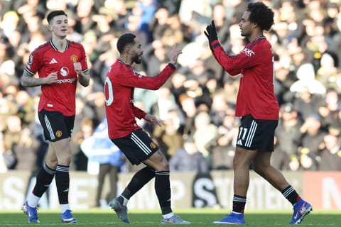 Manchester United's Brazilian striker Matheus Cunha (C) celebrates with Manchester United's Dutch forward Joshua Zirkzee (R) after scoring their first goal to equalise 1-1 during the English Premier League football match against Leeds United at Elland Road in Leeds, northern England on January 4, 2026.
