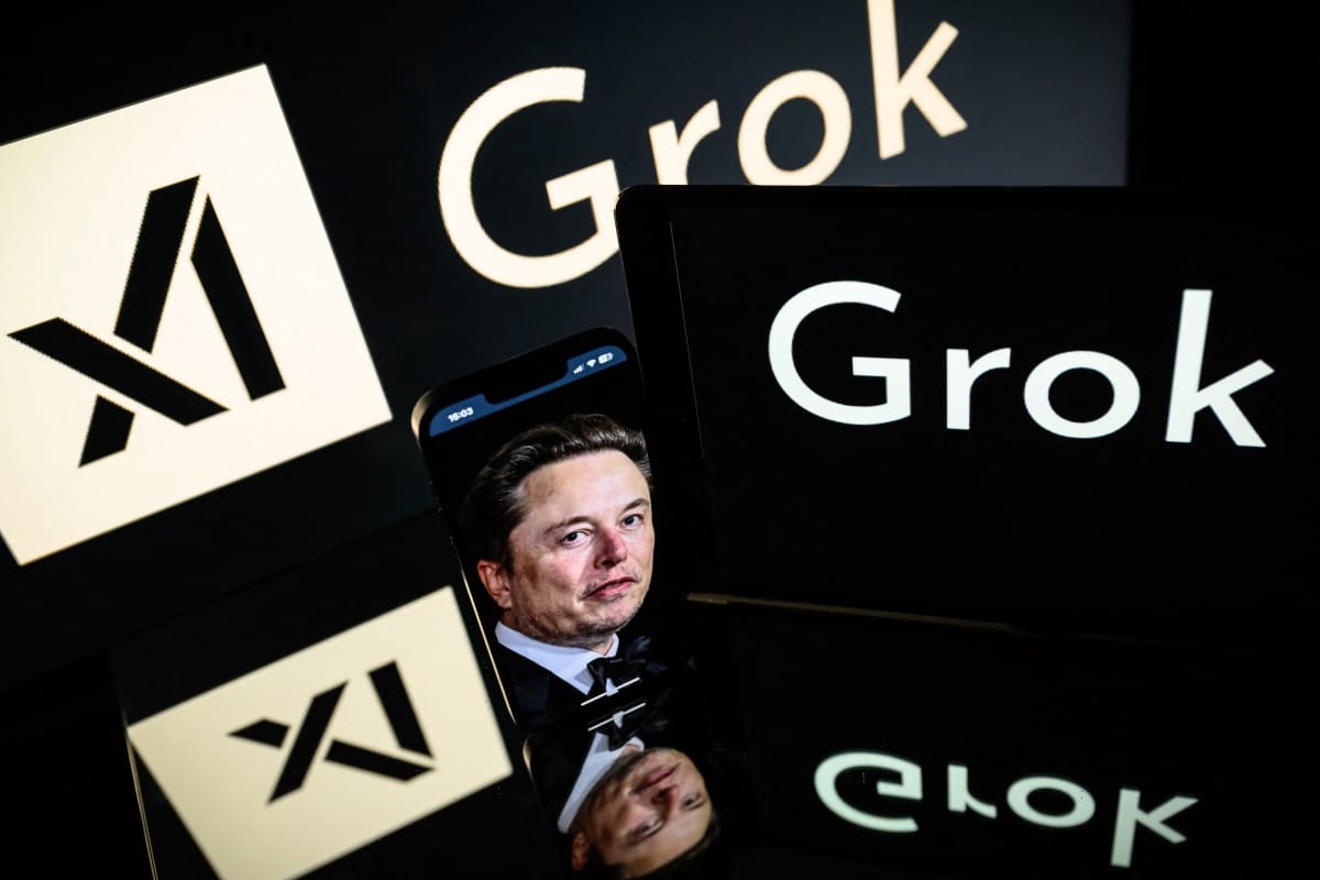 This photograph taken on January 13, 2025 in Toulouse shows screens displaying the logo of Grok, a generative artificial intelligence chatbot developed by xAI, the American company specializing in artificial intelligence and it's founder South African businessman Elon Musk.