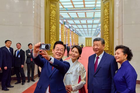 South Korean President Lee Jae Myung snapped a selfie with Xi Jinping using a smartphone gifted to him by the Chinese leader, who had joked at their last meeting that the device might be capable of spying.