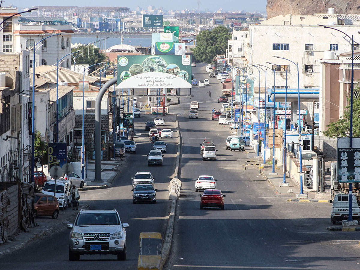 Cars drive through a street in Aden on December 31, 2025. 