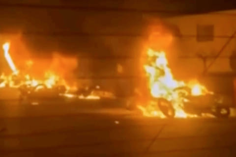 This frame grab from a video released by Iran state TV shows vehicles burning amid night of mass protests in Tehran.