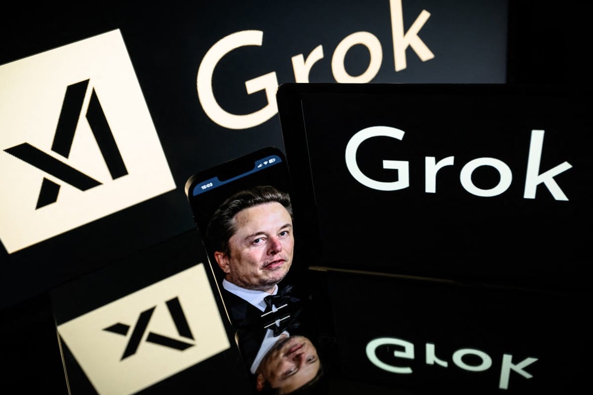 This photograph taken on January 13, 2025 in Toulouse shows screens displaying the logo of Grok, a generative artificial intelligence chatbot developed by xAI, the American company specializing in artificial intelligence and it's founder South African businessman Elon Musk.