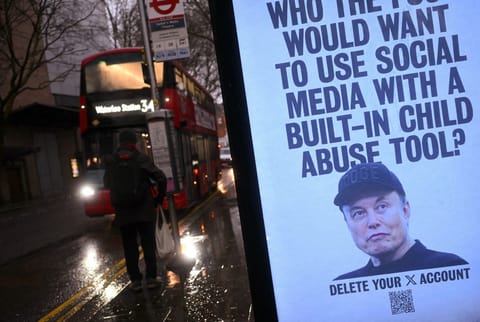 A poster featuring an image of US billionaire and businessman Elon Musk, calling for users of his X social media platform to delete their accounts due to the AI chatbot Grok's image-creation feature, is pictured installed in a bus stop by activists from UK collective 'Everyone Hates Elon', in London on January 13, 2026.