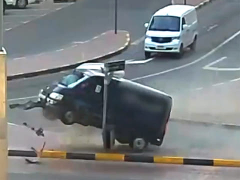 The impact is forceful enough to briefly lift the rear of the van off the ground