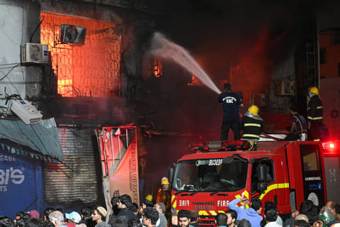 Firefighters douse a fire that broke out at a shopping mall in Karachi on January 18, 2026.  