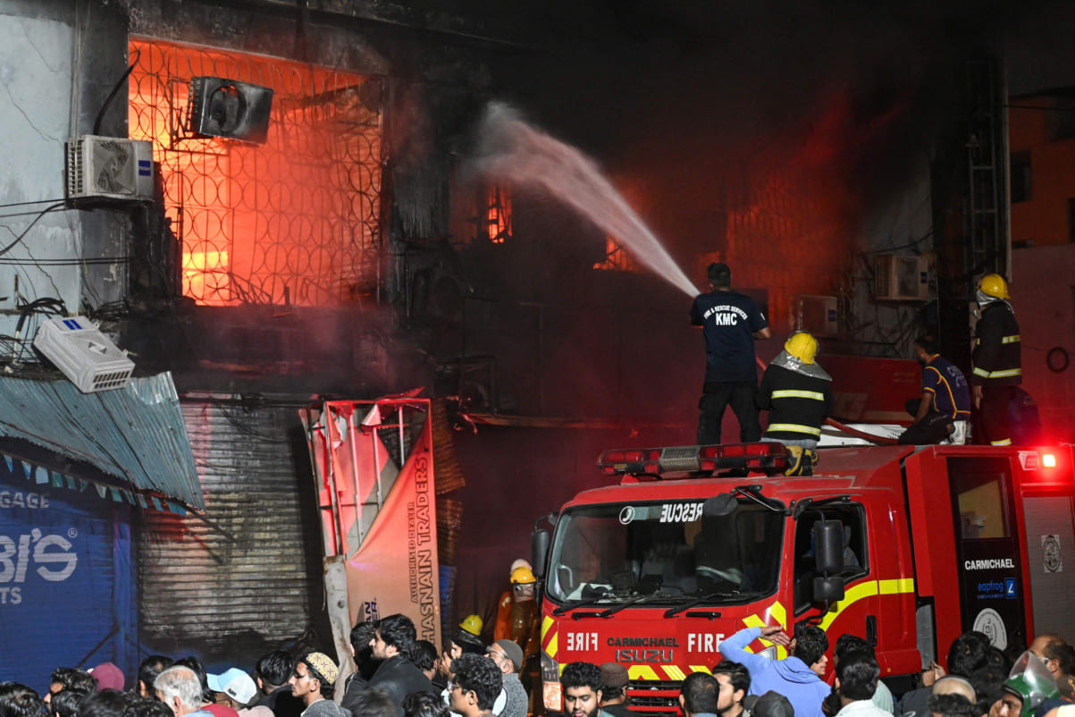Firefighters douse a fire that broke out at a shopping mall in Karachi on January 18, 2026.  