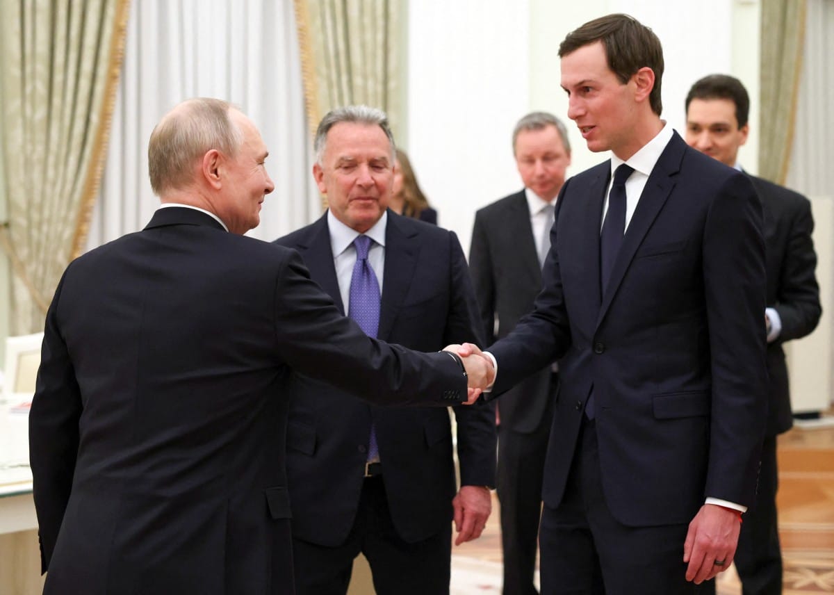 In this pool photograph distributed by the Russian state agency Sputnik, Russia's President Vladimir Putin welcomes US special envoy Steve Witkoff and US President Donald Trump's son-in-law Jared Kushner during a meeting at the Kremlin in Moscow on January 22, 2026.