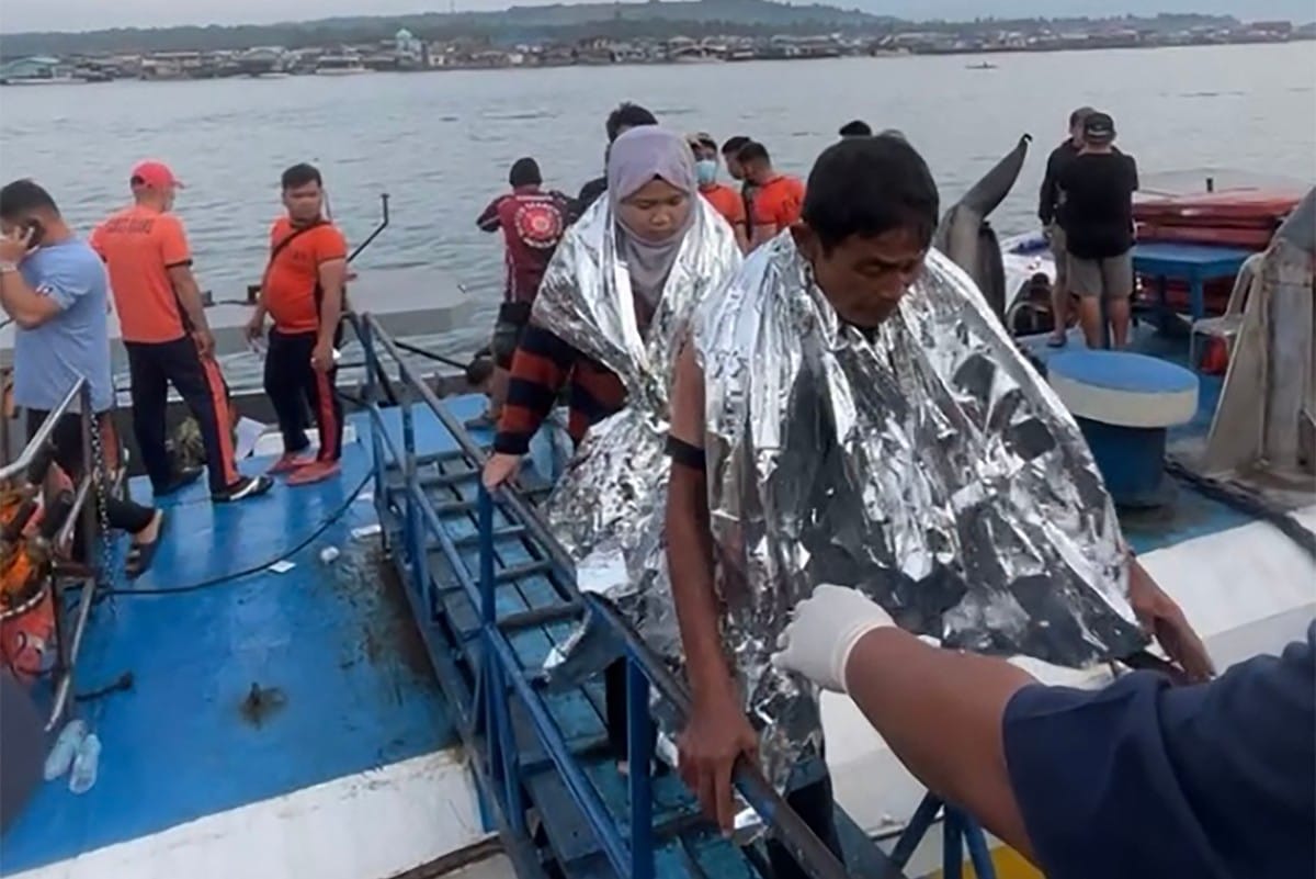 This screen grab from video footage taken and received on January 26, 2026 from Governor Mujiv Hataman shows rescuers assisting survivors of the sunken MV Trisha Kerstin 3 at a port in Isabela, Basilan province.