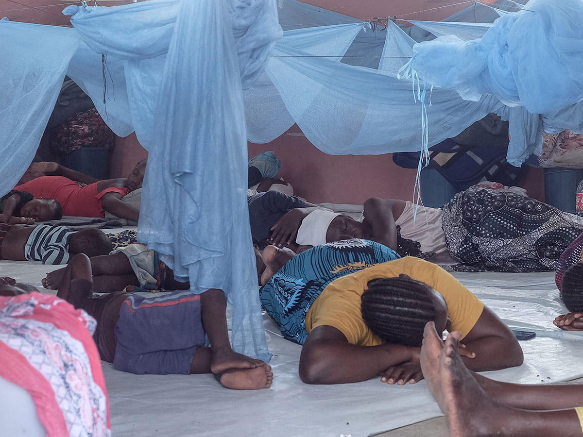A group of displaced people sleep on the floor at an emergency shelter in the town of 3 De Fevereiro, Mozambique, on January 27, 2026. 

