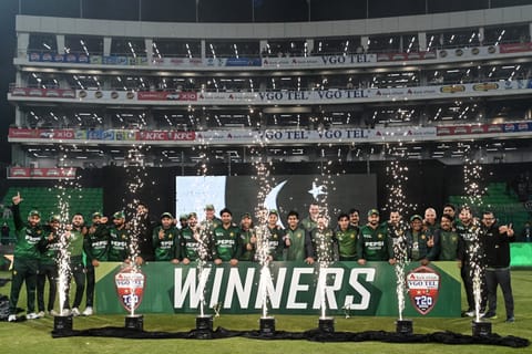 Pakistan's players pose for a group photo as they celebrate the team's win at the end of the third T20I against Australia at the Gaddafi Stadium in Lahore on February 1, 2026.