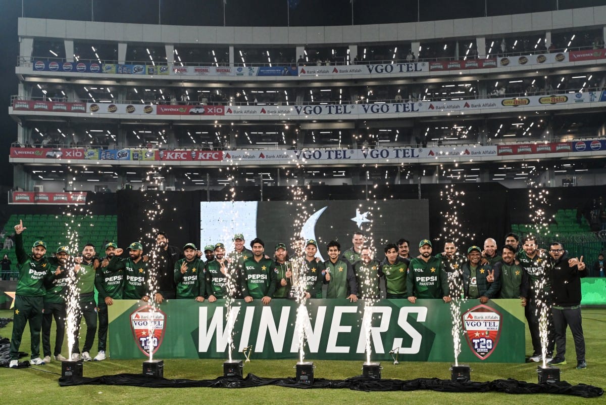 Pakistan's players pose for a group photo as they celebrate the team's win at the end of the third T20I against Australia at the Gaddafi Stadium in Lahore on February 1, 2026.