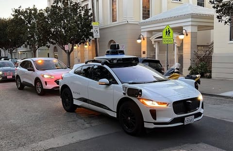 A Waymo driverless taxi stops on a street in San Francisco on Feb. 15, 2023. 