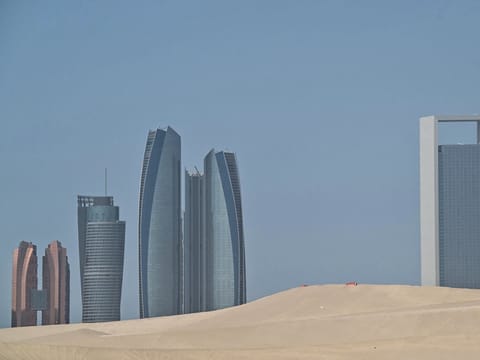 A photograph shows the Abu Dhabi skyline  