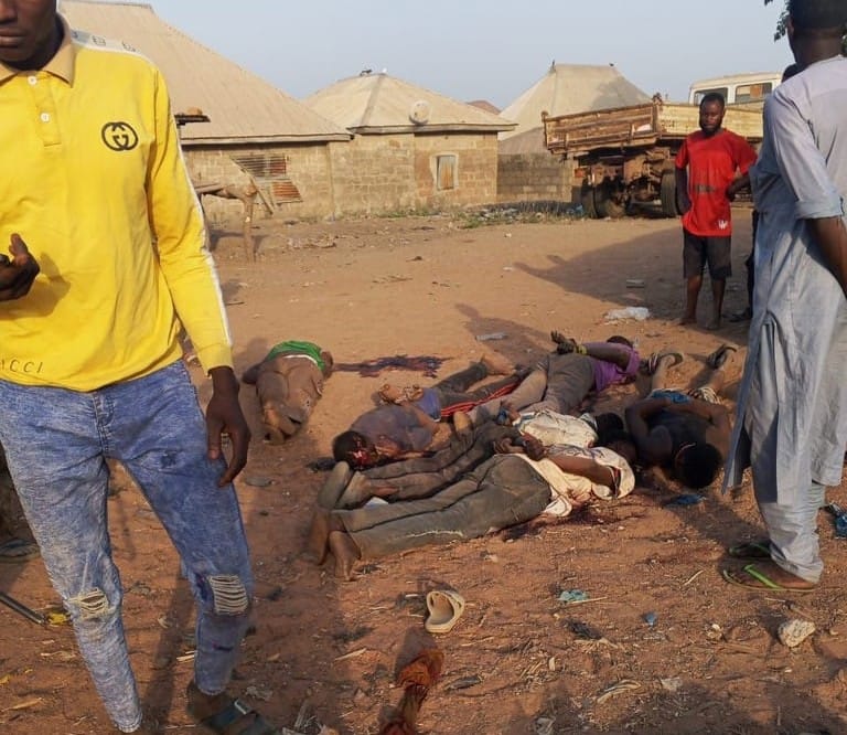 This photo provided by Kaiama TV shows people gathered around victims killed by armed extremists in the Woro community of western Nigeria, Wednesday, Feb. 4, 2026. (Kaiama TV via AP)
