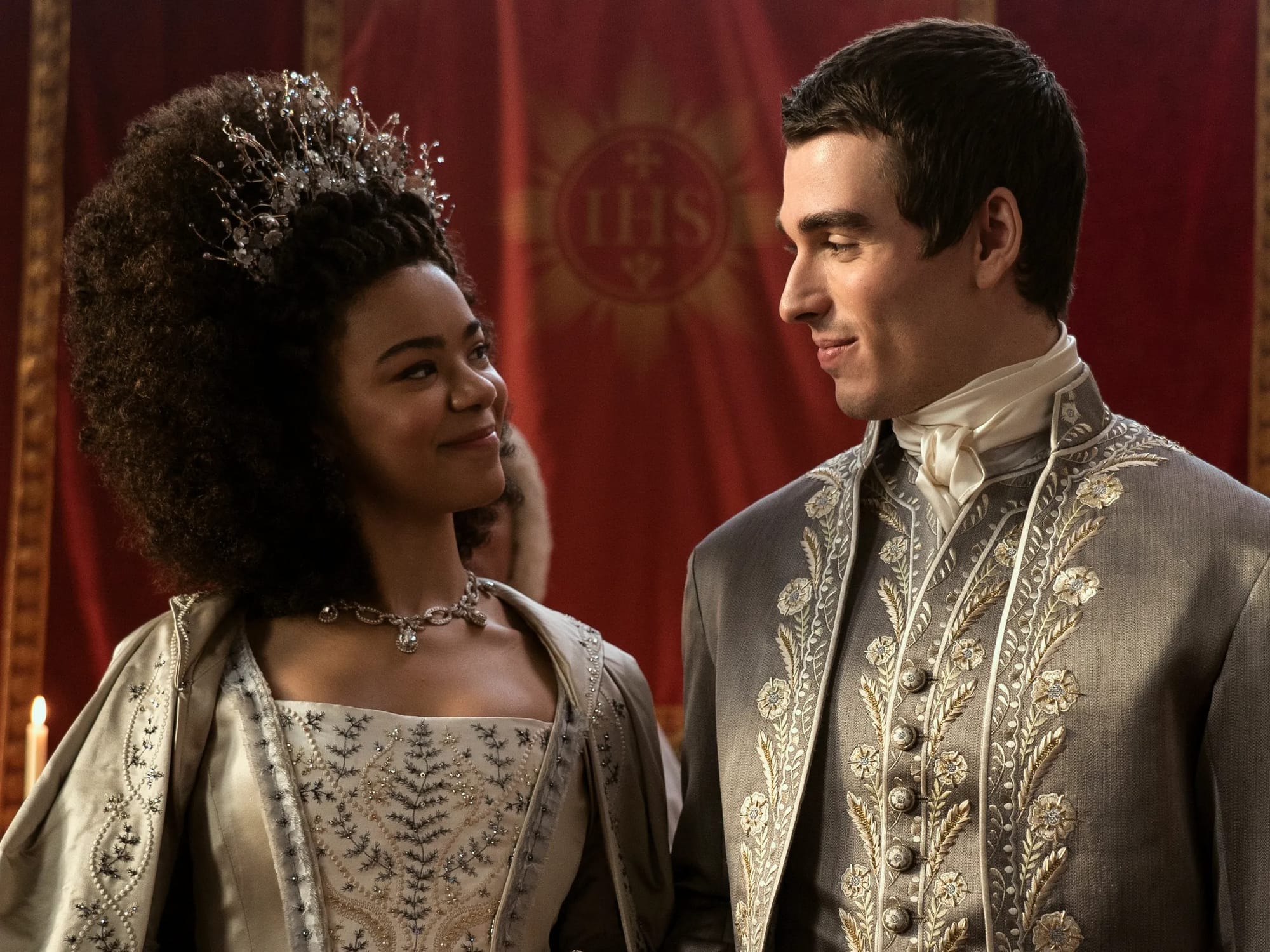 India Amarteifio as Young Queen Charlotte, and Corey Mylchreest as King George III. 