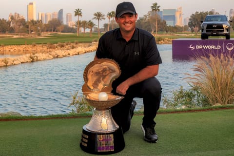US' Patrick Reed celebrates with the trophy after winning the Qatar Masters 2026 golf tournament at Doha Golf Club in Doha on February 8, 2026.