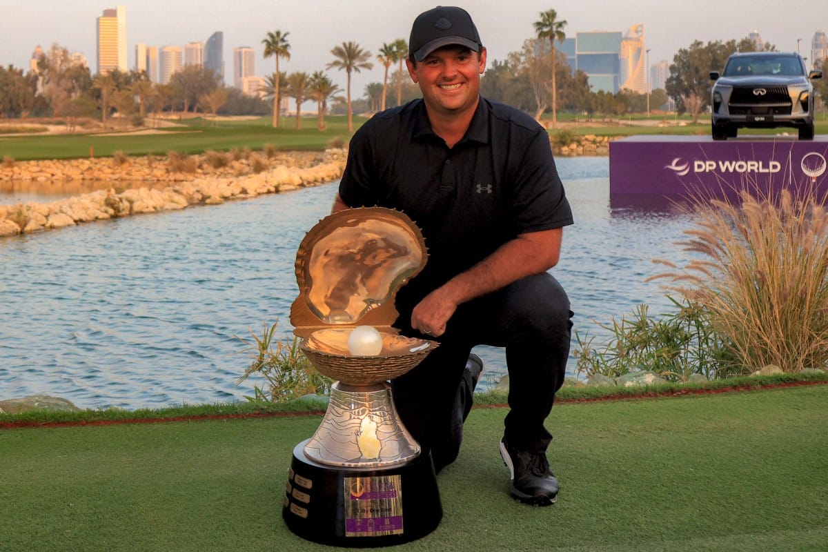 US' Patrick Reed celebrates with the trophy after winning the Qatar Masters 2026 golf tournament at Doha Golf Club in Doha on February 8, 2026.