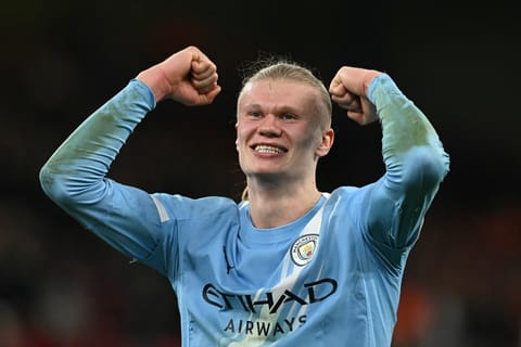 Erling Haaland celebrates his team's victory at Anfield 