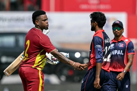 West Indies' Shimron Hetmyer (L) shakes hands with Nepal's Nandan Yadav at the end of the 2026 ICC Men's T20 Cricket World Cup group stage match between Nepal and West Indies at the Wankhede Stadium in Mumbai on February 15, 2026.