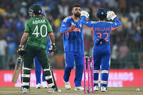 India's Varun Chakravarthy (C) celebrates with wicketkeeper Ishan Kishan after taking the wicket of Pakistan's Abrar Ahmed during the 2026 ICC Men's T20 Cricket World Cup group stage match between India and Pakistan at the R Premadasa Stadium in Colombo on February 15, 2026.