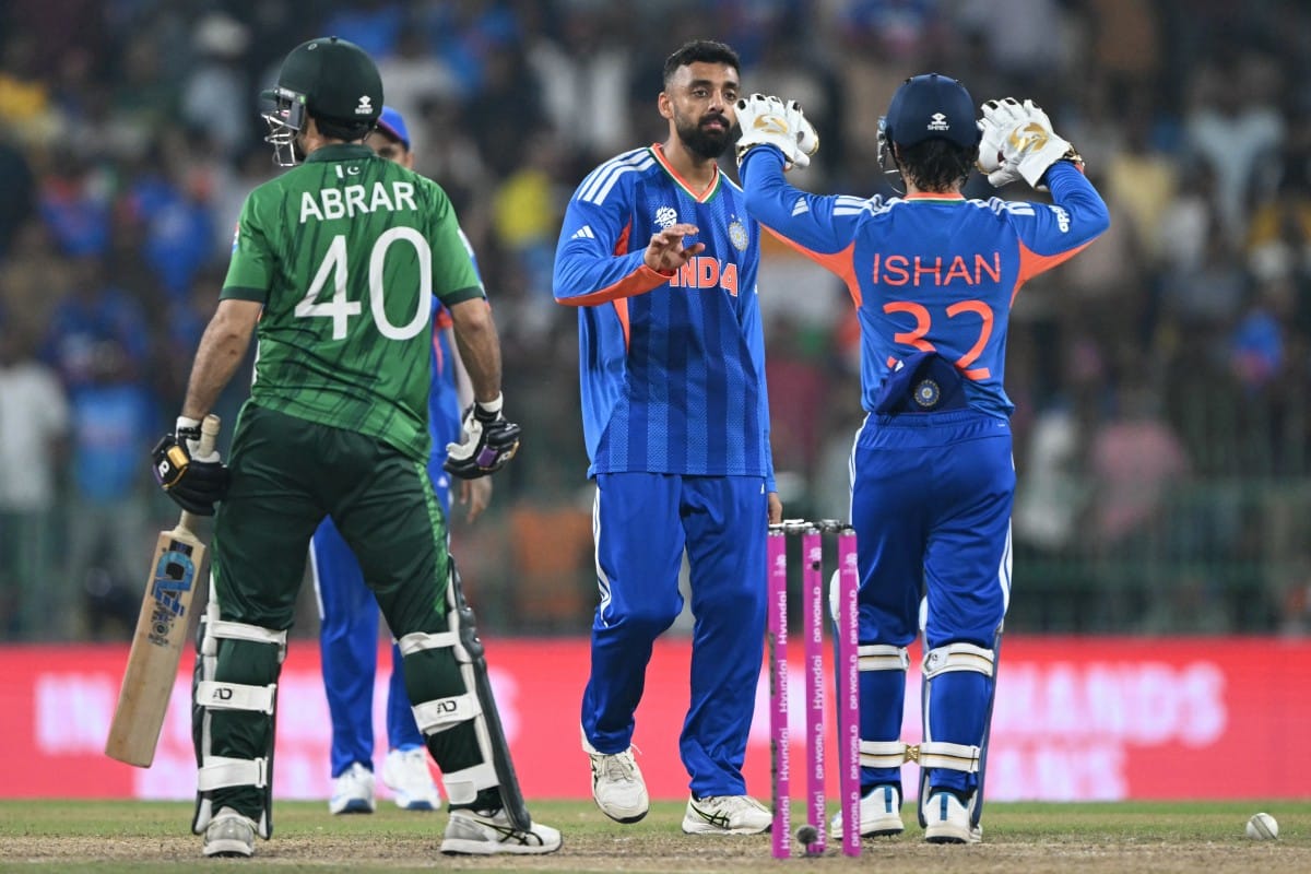 India's Varun Chakravarthy (C) celebrates with wicketkeeper Ishan Kishan after taking the wicket of Pakistan's Abrar Ahmed during the 2026 ICC Men's T20 Cricket World Cup group stage match between India and Pakistan at the R Premadasa Stadium in Colombo on February 15, 2026.