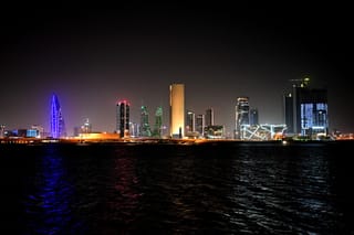 A picture taken on February 16, 2026, shows the skyline of the Bahraini capital Manama at night.
