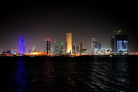 A picture taken on February 16, 2026, shows the skyline of the Bahraini capital Manama at night.