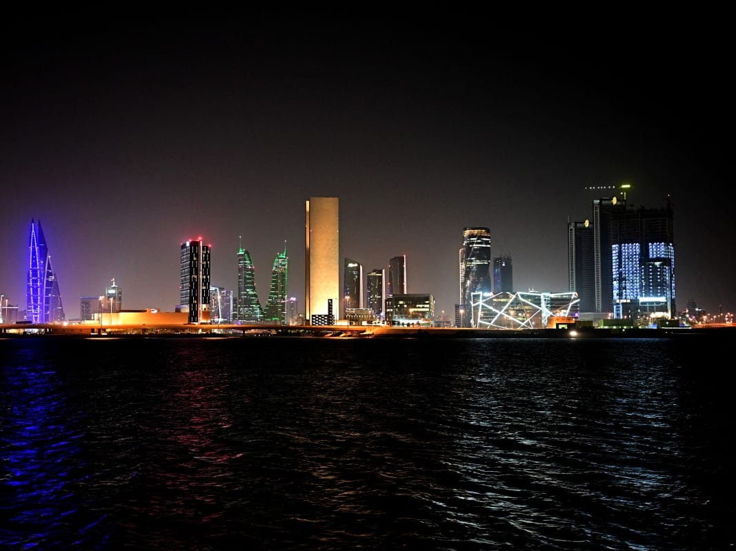 Taken on February 16, 2026, this picture shows the skyline of the Bahraini capital Manama at night.